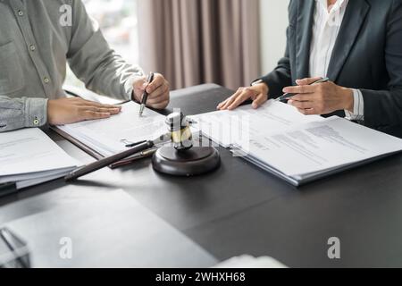 Lawyer Legal counsel presents to the client a signed contract with gavel and legal law. justice and lawyer Business partnership Stock Photo