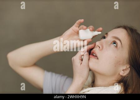 Young woman has flu catarrh ill sick disease treatment cold hold medicine nasal spray. Stock Photo