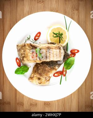 Fried fish on white plate, top view Stock Photo