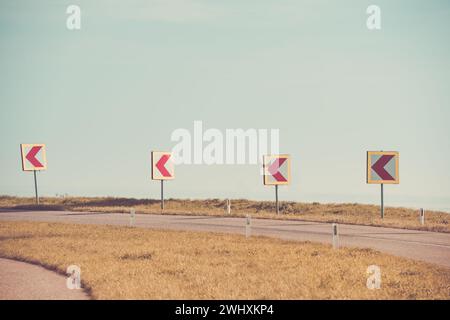 Turn left sign on a country road Stock Photo