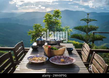 Dinner with a Thai BBQ at sunset in the mountains of Thailand Stock Photo