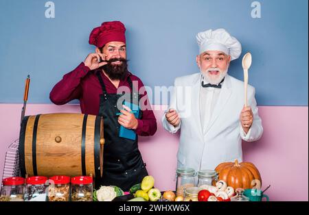 Professional chef man showing sign for delicious. Male chef in white uniform with perfect sign. Serious satisfied bearded chef, cook or baker Stock Photo