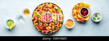 Loaded nachos panorama. Mexican nacho chips with beef, overhead Stock Photo