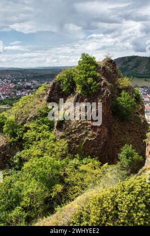 Sun shining on a rock with green plants at the top of Rotenfels overlooking Bad Munster, Germany on a spring day. Stock Photo