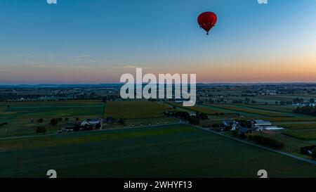 Aerial View of a Red Hot Air Balloon, Floating Across Rural Pennsylvania, on a Sunny Morning Stock Photo