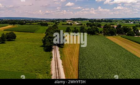 Aerial View of Planted Farmlands, With Barn and Silos, on a Sunny Summer Day Stock Photo