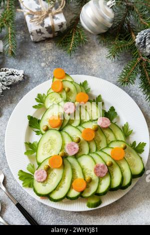 Christmas appetizer. Christmas tree from a salad olivier on a gray stone background. Stock Photo