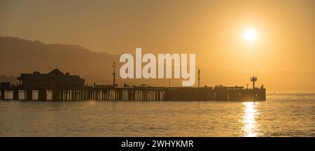 Clear, Orange sunrise, Santa Barbara coast, Stearns Wharf, Coastal view, Morning glow, Sunlight reflection, Coastal beauty Stock Photo