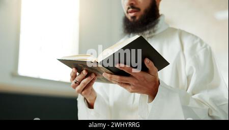 Muslim man, reciting and mosque for reading quran with faith, idea or culture for worship, praise or study. Islamic person, religion and peace in book Stock Photo