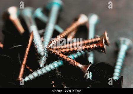 Different Kind of Screws on a table in a workshop Stock Photo