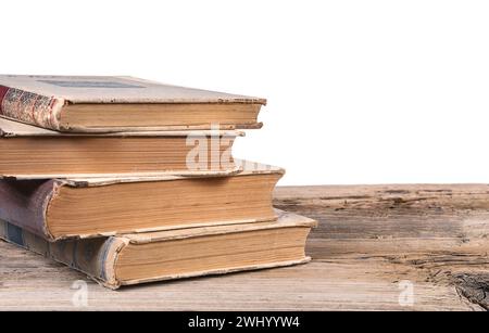 Old books on textured wooden surface isolated on white background Stock Photo