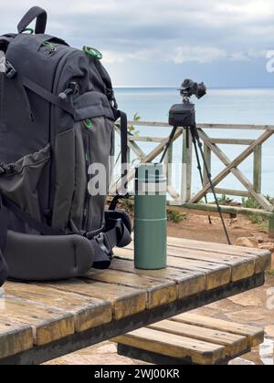 Photo backpack and thermos lie on the table in front of the camera Stock Photo
