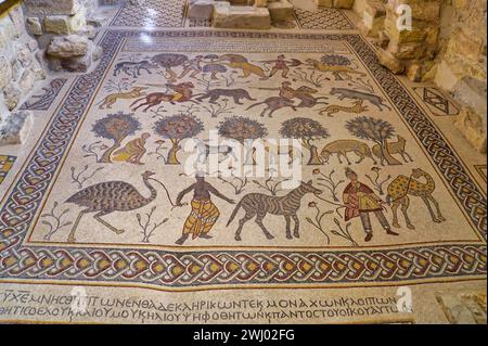 Floor mosaic from the 6th century in Basilka from the Byzantine period on Mount Nebo. Cross-shaped baptismal font in the backgro Stock Photo