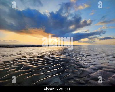 Mudflat landscape with colorful clouds at sunset, Norderney Island, North Sea, Germany, Europe Stock Photo