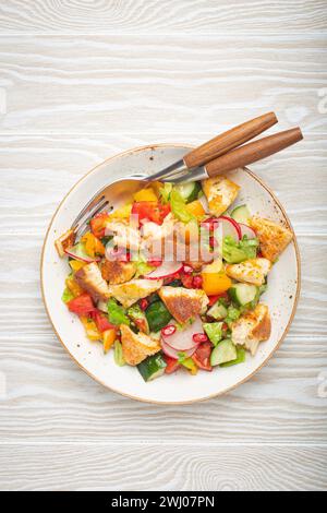 Traditional Levant dish Fattoush salad, Arab cuisine, with pita bread croutons, vegetables, herbs. Healthy Middle Eastern vegeta Stock Photo