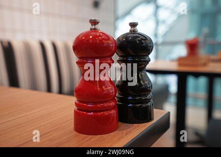 Close up Ceramic salt and pepper seasoning shaker on wooden table Stock Photo