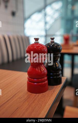 Close up Ceramic salt and pepper seasoning shaker on wooden table Stock Photo