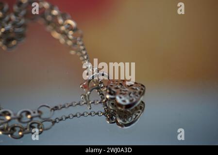 Heart-shaped charm pendant on a delicate chain necklace Stock Photo