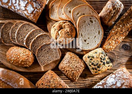 Assorted bakery products including loaves of bread and rolls Stock Photo