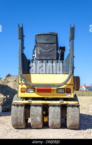 Road construction vehicle. Road construction site with roller compactor working asphalt road Stock Photo