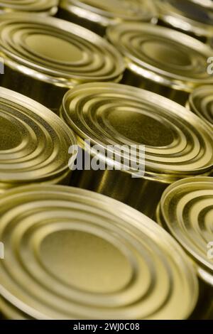 Large group of blank unlabelled round tin cans, abstract food industry background Stock Photo