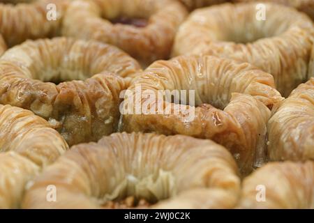 Traditional Turkish dessert, baklava, filled with crushed walnuts, abstract food background Stock Photo