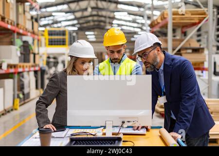 Engineer, foreman consulting with director in modern industrial factory, talking about new production project or investment. Team management in Stock Photo