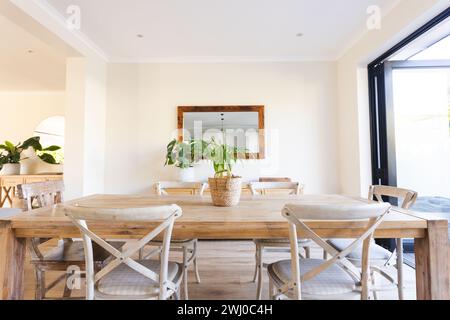A bright dining room at home, showcasing a wooden table and chairs Stock Photo