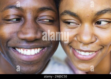 Young couple enjoys using a smart home app, smiling together. Stock Photo