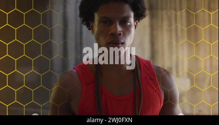 Young African American man stands confidently in a gym Stock Photo