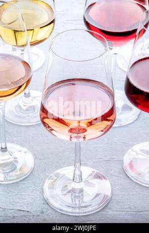 Wine glasses at a tasting. Rose, red, and white wine, drinks on a table Stock Photo