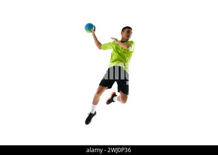 Dynamic image of young man in uniform, handball player in motion during game, practicing, jumping with ball against white studio background Stock Photo