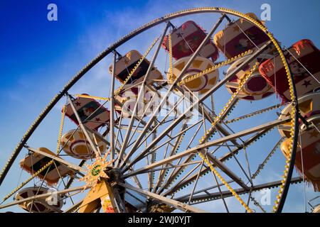 Inside an amusement park the colors of the Ferris wheel Stock Photo - Alamy