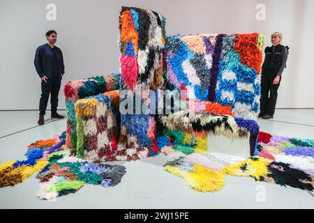 Barbican Art Gallery, London, UK, Staff with Sarah Zapata, To Teach Or To Assume Authority, 2018-19. 12th Feb 2024. Spanning intimate hand-crafted pieces to large-scale sculptural installations, Unravel: The Power and Politics of Textiles in Art brings together over 100 artworks by 50 international practitioners who use textiles, fibre and thread to communicate ideas about power, resistance and survival. It runs til 26th May, 2024. Credit: Imageplotter/Alamy Live News Stock Photo