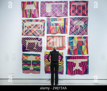Barbican Art Gallery, London, UK. 12th Feb, 2024. Staff with Yee I-Lann weaving work Tikar/Maja, 2018. Spanning intimate hand-crafted pieces to large-scale sculptural installations, Unravel: The Power and Politics of Textiles in Art brings together over 100 artworks by 50 international practitioners who use textiles, fibre and thread to communicate ideas about power, resistance and survival. It runs til 26th May, 2024. Credit: Imageplotter/Alamy Live News Stock Photo