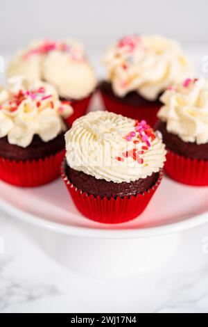 Red Velvet Cupcakes with White Chocolate Ganache Frosting Stock Photo