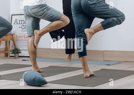 Two people practicing partner stretching exercises in a studio. Stock Photo