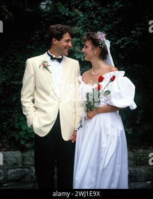 Young couple. Wedding bride & groom outdoors in garden. Stock Photo