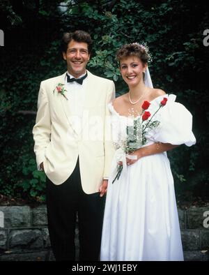 Young couple. Wedding bride & groom outdoors in garden. Stock Photo
