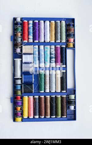 Rolls of thread, spools of thread in different colors for sewing work. Stock Photo