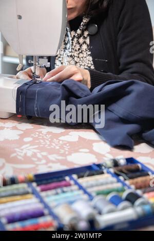 Detail of sewing work execution. Recycling clothes at home to reduce waste and avoid fast fashion. Stock Photo