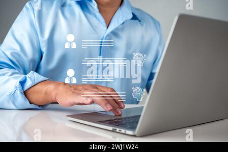 Businessman use computer technology to type live chat with intelligent computer to find information, ask, answer with an artificial intelligence syste Stock Photo