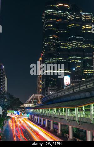 Passing metro train bts on an overpass among and traffic lights skyscrapers at Chong Nonsi pedestrian Empire Tower bridge in Bangkok, Thailand 27 dece Stock Photo