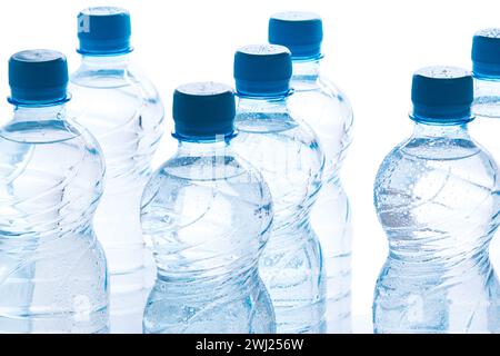 Blue bottles of pure still water against white background Stock Photo