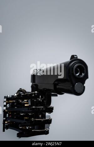 Real robot's hand with handgun. Concept of AI takeover and technological singularity Stock Photo