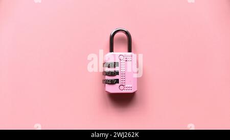 Safety and protection concept. Pink padlock isolated on a pink background Stock Photo