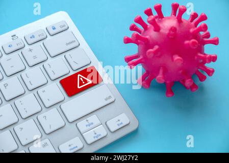 Concept of cyber threat, hacker, computer virus. Danger sign on computer keyboard. Stock Photo
