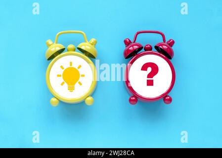 Concept of creative thinking idea and problem solving. Light bulb icon and question mark over alarm clock. Stock Photo