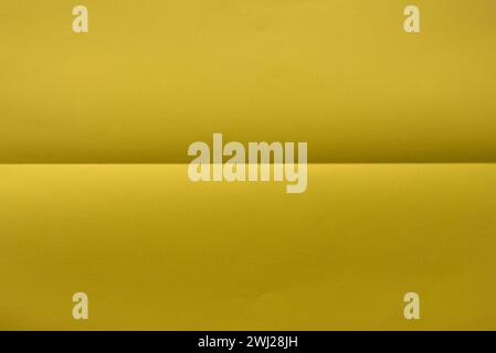 Folded yellow color paper for background. Stock Photo