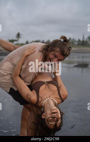 Young cheerful happy couple in love fooling around on the beach. Stock Photo